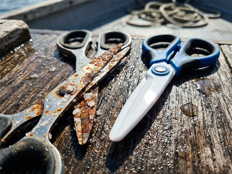 Rusted traditional steel pliers vs a clean ceramic fishing scissor exposed to salty ocean water