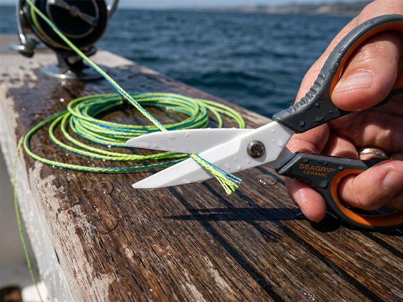 Ceramic fishing scissor making a sharp, clean cut on a braided PE fishing line without fraying