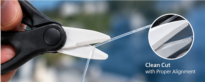 Close-up of scissor blade alignment when cutting fluorocarbon fishing line Close-up of scissor blade alignment when cutting fluorocarbon fishing line